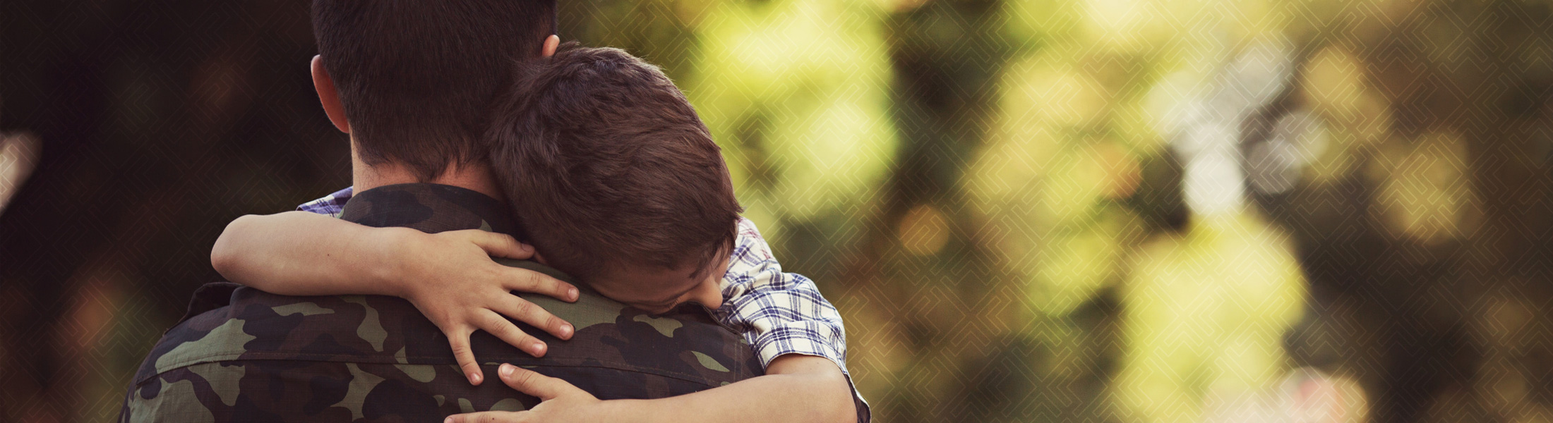 Army man hugging child