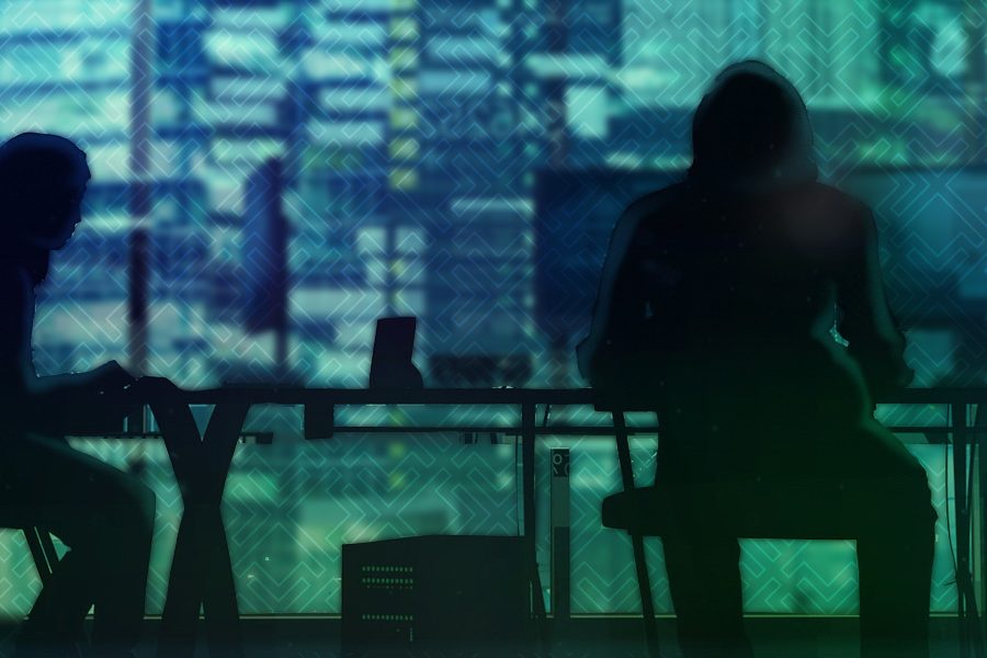 people sitting at a desk coding