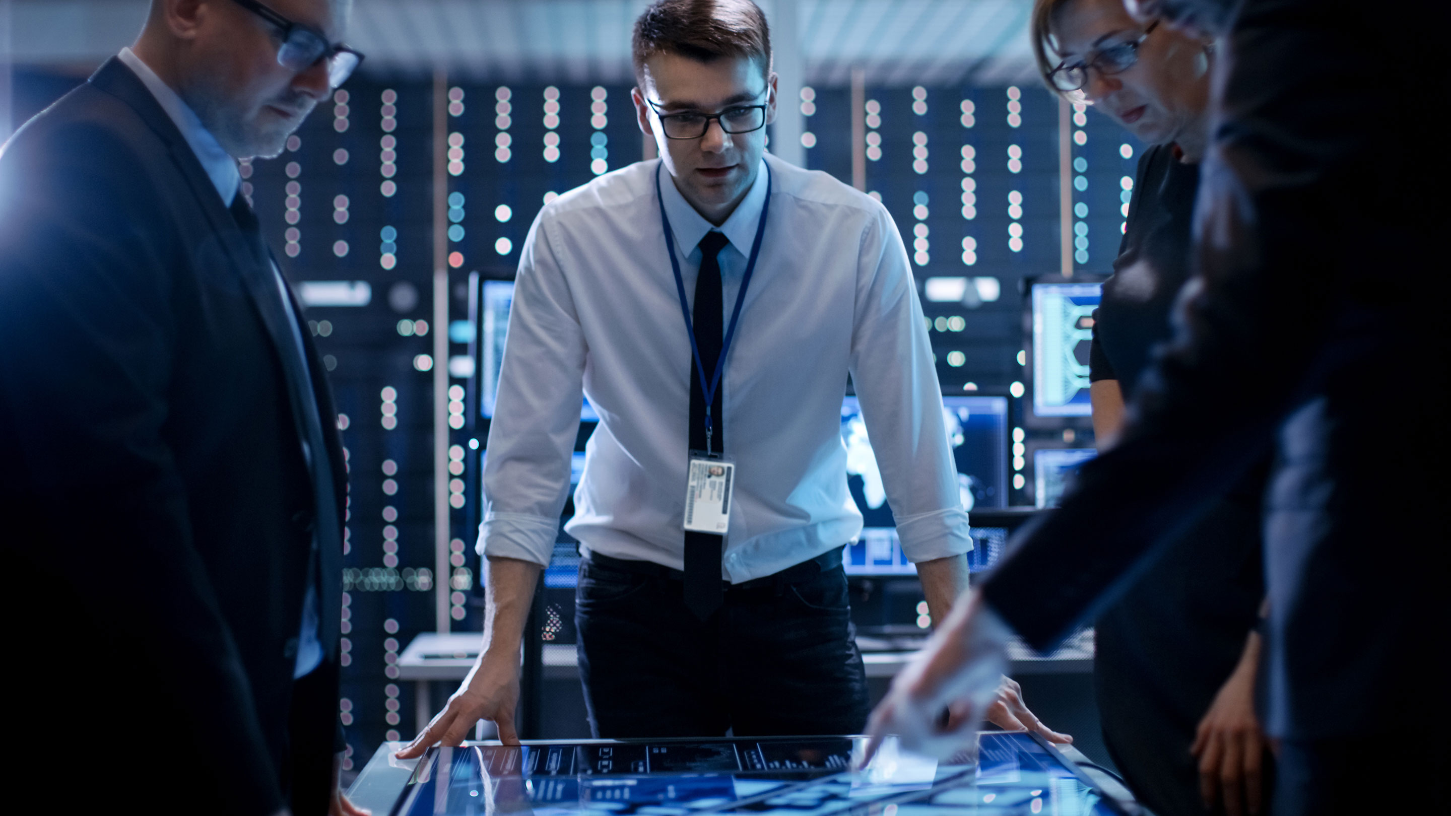 Agents standing around a table talking