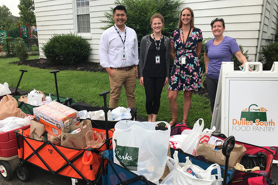 ECS employees donating to a food drive