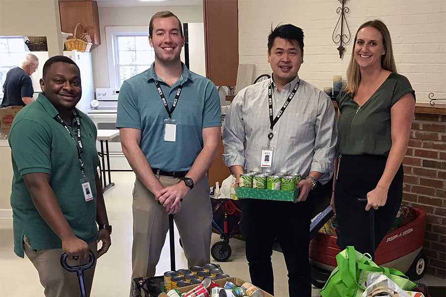 ECS employees donating to a food drive