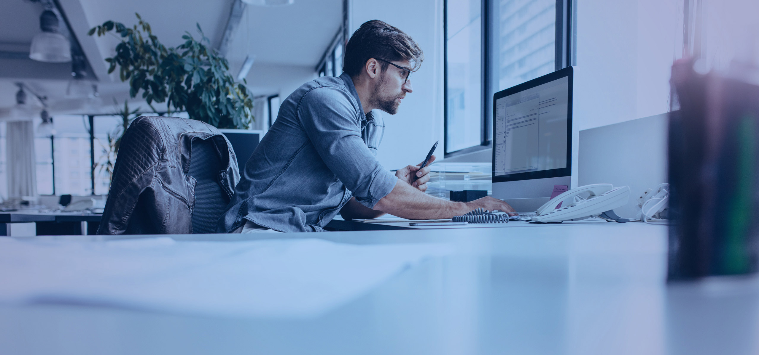 Man at a desk looking at a computer