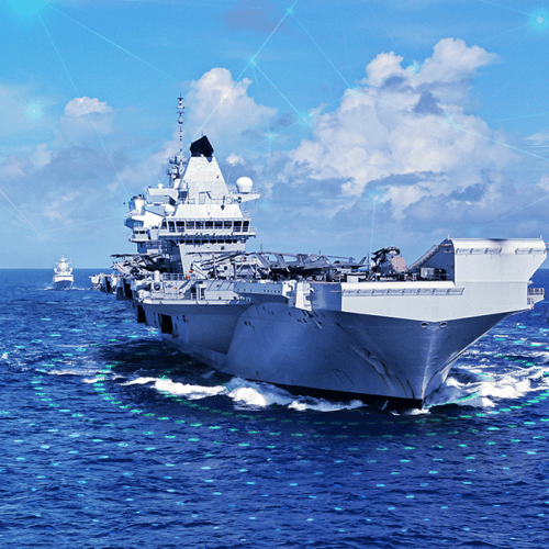 Multiple aircraft carriers and battleships are seen on the ocean.